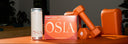 OSIA products including a box, can, and dumbbells with a neon sign in the background.